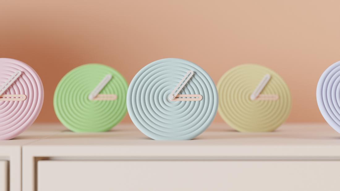 Row of round clocks with concentric ripple faces in pastel colours